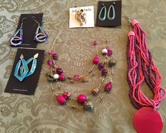 Lots of necklaces, rings, pins, bracelets of all types and colors