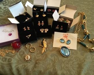 Lots of necklaces, rings, pins, bracelets of all types and colors