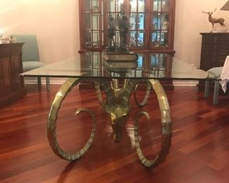 These two large brass ram's heads make up one incredible desk or table