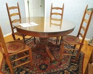 Antique table fitted with glass top... 4 of 6 ladderback  chairs
