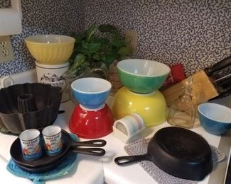 Vintage kitchen--pyrex bowls, cast iron skillets, cast iron bundt pan, Tupperware coasters