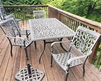 Cast aluminum table with 4 chairs, umbrella and stand and cushions