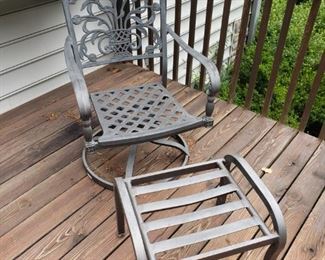 One of 2 swivel chairs with ottoman and cushions
