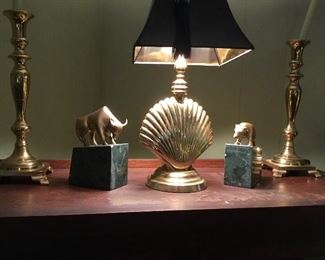 Large brass candlesticks, brass shell lamp and brass and marble bull and bear bookends.