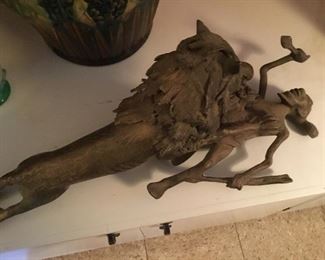 Interesting bronze sculpture...lion attaching an African warrior. Some damage to the lion's tail.