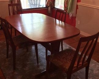 Teak Dining Room Table and Upholstered Chairs. 37 1/2" W x 28 1/2" H x 63" L (81" L with leaf).