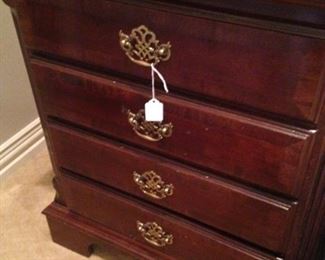 One of two four-drawer nightstands