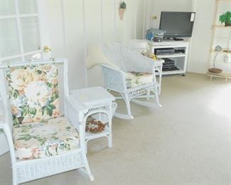 White Wicker on the sun porch . One of three rockers.