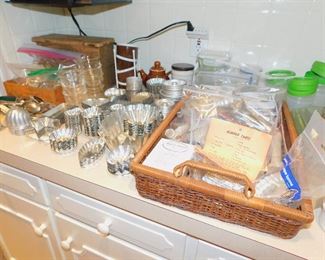 Large collection of metal tart tins and cookie cutters