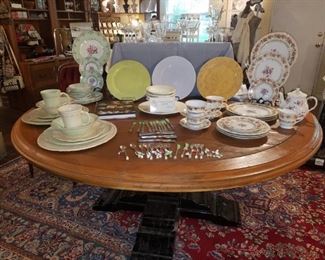 Large Round Table and china/dish collection including Vietri from Kimberly's Closeout. Several cocktail serving pieces of flatware. Crystal glasses.