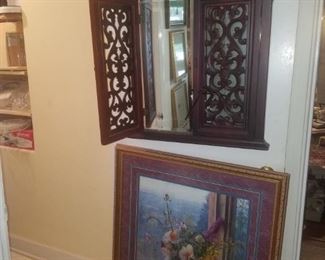 Heavy hanging mirror with wooden lattice-type front, framed art.