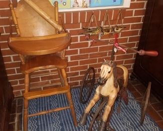 Wooden Braves bat, wooden high chair with table top, antique horse tricycle, rug, and more.