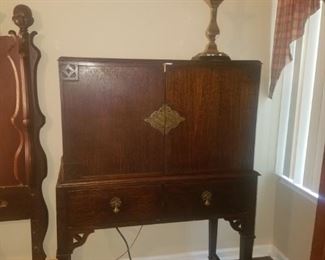 Antique buffet with silver drawer. Brass table lamp.