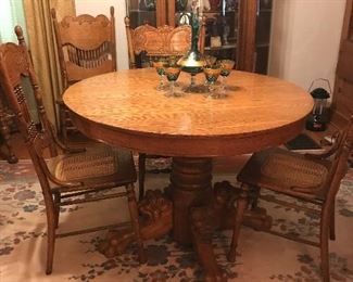 This is an incredible oak Round table.  Notice the lion carving on each leg, the paws in such detail.  Chairs are also beautiful and unique.