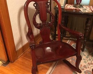 Mahogany Rocking Chair with open back featuring Sea Serpent carving on back and arms