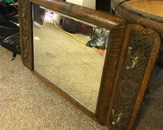 This oak mirror features beveled glass and coat/hat hooks.  Very heavy.
