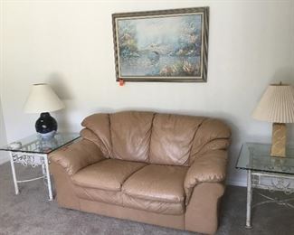 Tan leather loveseat / 2 metal and glass side table / lamps