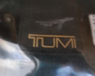 7 piece set of Tumi luggage in hunter green, on wheels with plastic covers to protect them. In near perfect condition! Some of these pieces have price tags on them for $385 a piece.