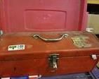 Red Metal Tool Box with Metal Handle tray and some tools, with plastic and galvanized pipes.