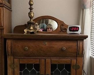 Leaded glass night stand matches the king bed set.
