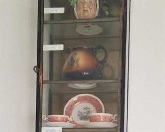 Glass display case. Sara Gump Mug, Monk Pitcher, and 10 pc place setting of Moroccan Spode. All priced separately.