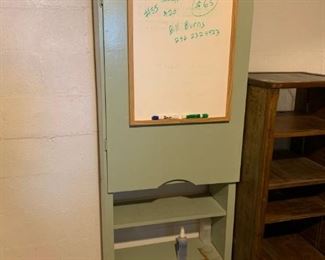 #57 Green Painted Bookshelf w/door w/pegboard inside, whiteboard front 27x11x72 $75.00