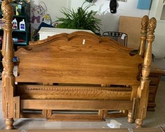 #81 Kincade Queen oak four post bed frame as is the pineapple finial is not attached $200.00