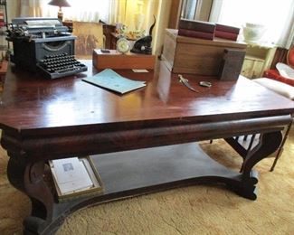 oversized mahogany desk, typewriter
