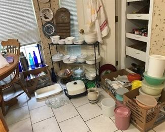 Corning ware, Tupperware, Vintage aprons, pantry items and canned goods.