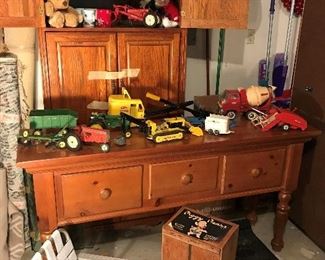 Sofa Table, Vintage TonkaTrucks. Tonka Trencher, Shovel, Stables, Concrete Mixer, Tru-Scale Tractor & Implements, Plow, font loader.  John Deer Tractor and implements.
 