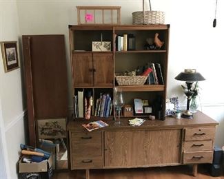 In the office is a credenza with bookshelves on top.