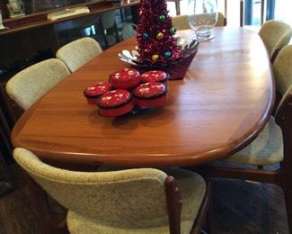 Mid-century teak Dyrlund table with 6 chairs, 2 leaves & table pads
