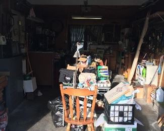 Miscellaneous chairs, egg crates, yard tools, bolts, screws by the bucket full, wood working magazines, National Geographic mags, etc
