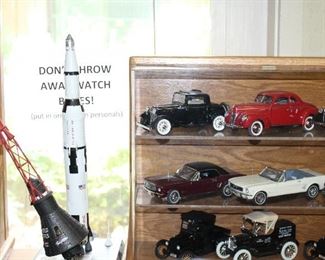 INDOOR, BACK OF HOUSE THROUGH HOLDING AREA, Saturn V SA506 $150/Friendship 7 Mercury Capsule $150
