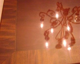 Reflection of the dining room light on the table.