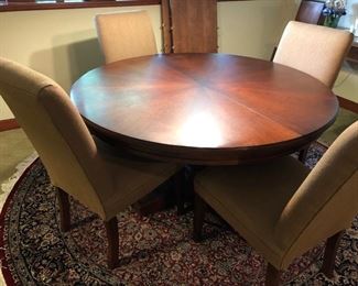 Round wood dining table with two leaves (see background)