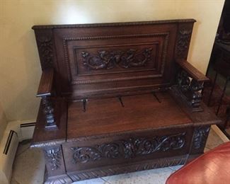 antique front hall seat , highly carved with lions and storage