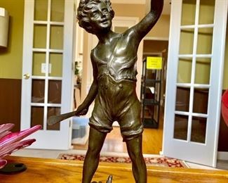 BRONZE SCULPTURE OF A BOY PLAYING A BALL GAME - CIRCA 1900. SIGNED