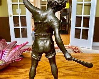BRONZE SCULPTURE OF A BOY PLAYING A BALL GAME - CIRCA 1900. SIGNED