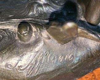 BRONZE SCULPTURE OF A BOY PLAYING A BALL GAME - CIRCA 1900. SIGNED