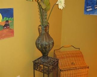 Wicker hamper, plant stand with floral arrangement, unframed art