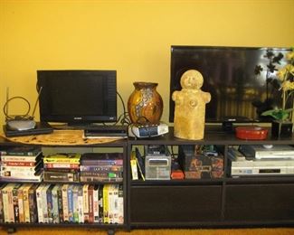 TV stands, TVs, VHS tapes, VCR player