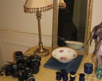 Cameras, mirror, candlestick lamp