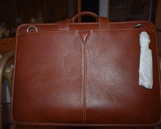 Top Quality Johnston and Murphy Leather Brief Case originally priced at $275. This satchel has never been used and is absolutely Beautiful with many extra features!