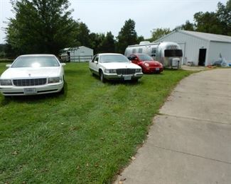 CADILLACS, VOLKSWAGEN, AIRSTREAM IN THE YARD, MODEL T COMING OUT SATURDAY MORNING