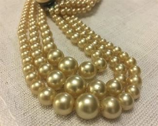Triple strand faux pearl necklace. 