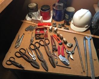 Snips of all sizes, one xxl wrench, hard hat, casters, utility knives, pruners, etc etc....