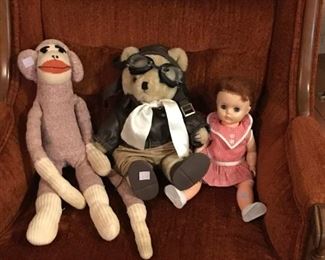 Sock Monkey, pilot bear, and plastic baby doll