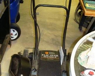 Electric flip over lawn mower