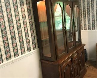 Lighted glass shelf china cabinet with plate racks and silver drawer